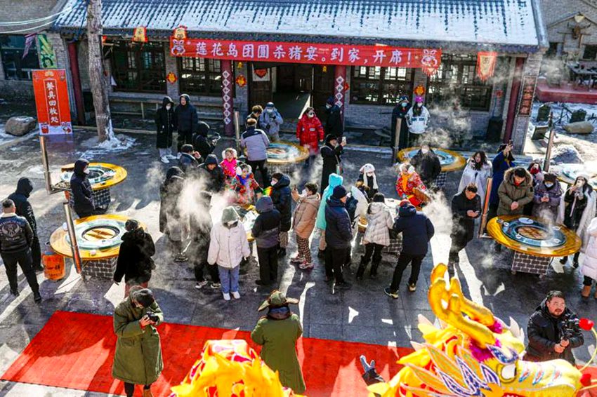 鄉村年豬文化節上，游客圍著鐵鍋燉大快朵頤。長春市朝陽區供圖
