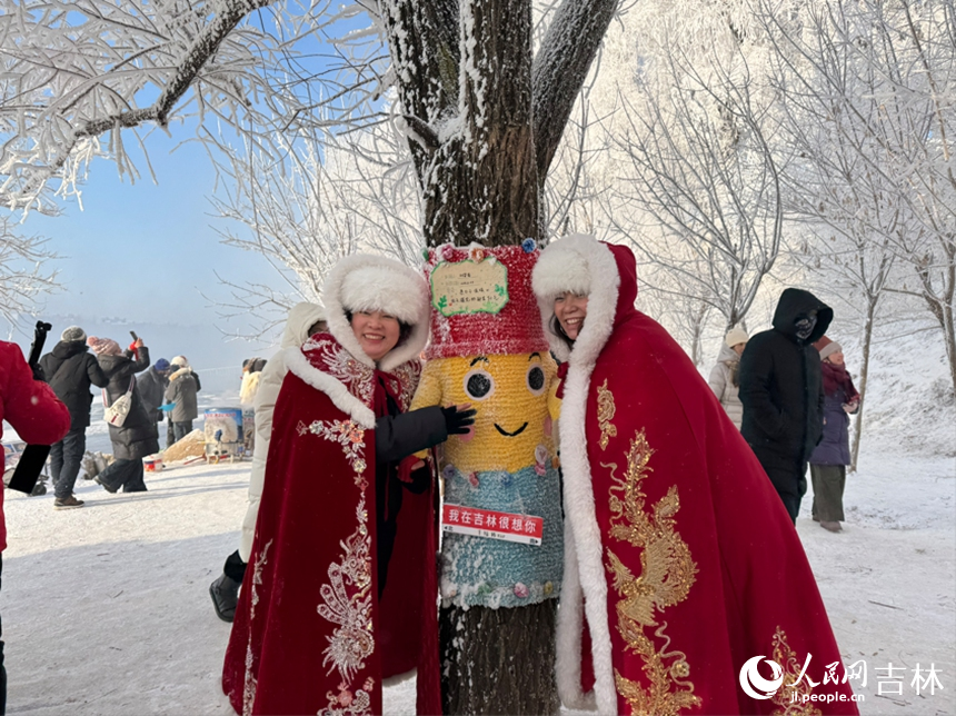 游客身披喜庆的红色披风，围绕着装饰可爱的树桩拍照留念。人民网记者 李思玥摄