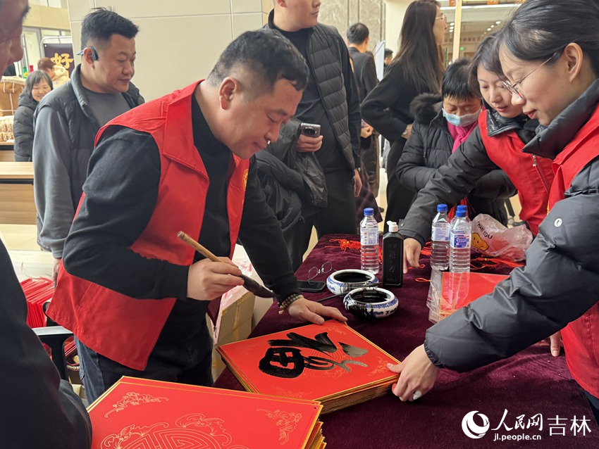 书写赠送福字春联的专区墨香四溢,年味扑面而来。人民网记者 李思玥摄